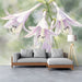 A bright study featuring the watercolor lily floral mural behind a tufted headboard.