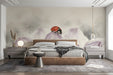 A cozy bedroom featuring a soft floral ladybug mural on the main wall with light wooden crib decor.