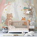 Nursery room featuring a cute woodland animal mural on the main wall behind a white crib