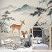 A quiet kid's room workspace decorated with a calming mist-covered mountain and forest mural.