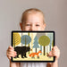Modern playroom interior with a woodland creature wall mural, styled with simple light wood furniture.