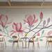 Light-filled cafe space with botanical wall mural and simple wooden desk furniture