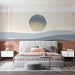 Minimalist bedroom with a calm abstract sunset wall mural behind a wooden desk