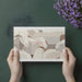 Modern home office with a minimalist cream-toned sheep wallpaper and contemporary desk accessories