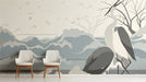A modern living room featuring the heron and wave mural behind a light grey sofa with minimalist decor.