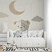 A cozy bedroom featuring a neutral bear mural behind a white wooden crib and soft linen bedding.