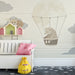 A calm play area with the whimsical animal mural on the wall, styled with neutral wooden toys and natural light.