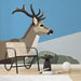 Geometric stag mural installed on a light-filled entryway wall behind a modern sofa.