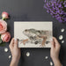 Close up of an iguana wall mural styled in a peaceful minimalist bedroom