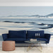 Abstract beach landscape mural used as an accent wall in a serene study with light furniture.