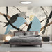 Small library space featuring an artistic bird mural as a focal point for a reading chair.