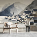 Study with a serene mountain village mural on the main wall behind a modern sofa.
