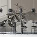 Warm taupe botanical mural installed as a feature wall behind a wooden desk in a home office.
