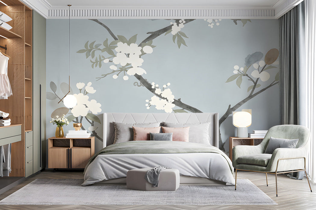 Floral bedroom mural wallpaper featuring delicate ink-wash cherry blossoms behind a light oak bed.