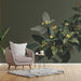A sophisticated study interior featuring the sage green botanical wallpaper pattern and warm brass lighting fixtures.