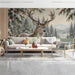 A cozy bedroom featuring a snowy stag forest wall mural behind a minimalist wooden bed frame.