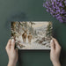 A bright, peaceful living room with a large-scale winter forest landscape mural.