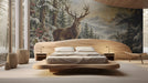 Winter stag mural installed on a bedroom wall behind a plush bed with neutral bedding