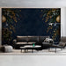 Living room accent wall with a dark blue and gold festive garland mural behind a velvet sofa.