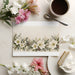 Botanical wallpaper featured in a sophisticated dining room with wooden furniture and neutral decor.