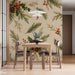 A cozy dining room featuring the pinecone holly wallpaper behind a mid-century modern sofa.