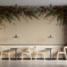 A cafe entrance featuring a classic holiday-inspired pine and holly wall mural.