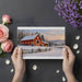 A cozy home office space with a snowy winter farm landscape mural behind a mahogany desk