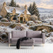 Cozy living room featuring a snowy countryside mural, paired with a rustic wooden table.