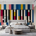 Modern living room interior with colorful musical key wallpaper behind a sofa