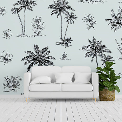 White sofa in a room with a wall featuring black palm tree and plant decals.