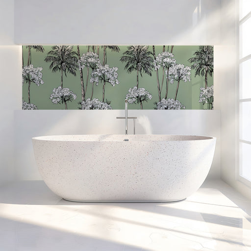 Modern white freestanding bathtub in a bathroom with a decorative wall panel featuring palm trees and flowers.