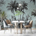 Dining area with a table and chairs against a tropical wallpaper background