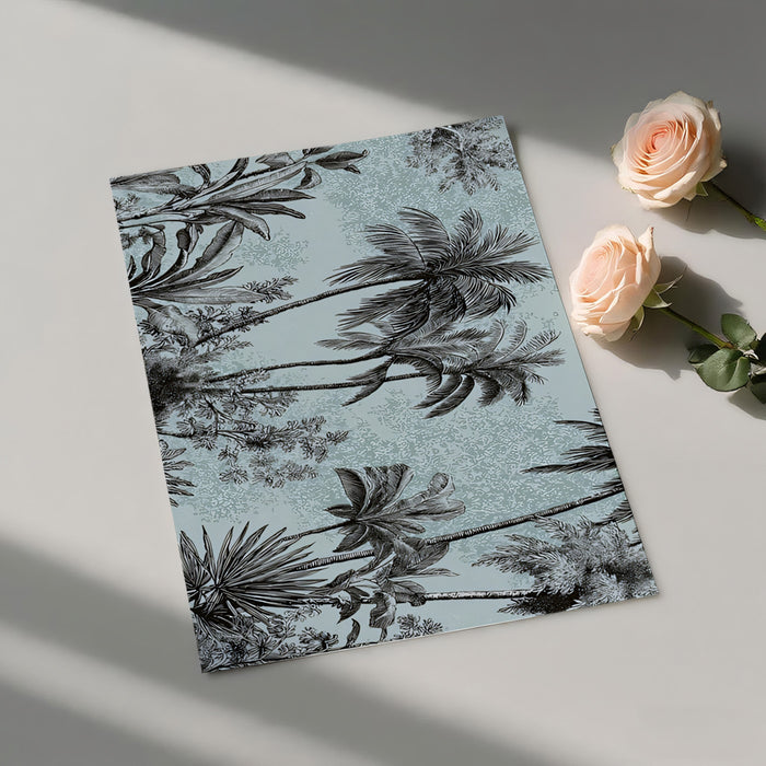 Notebook with palm tree design on a light surface with roses
