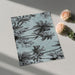 Notebook with palm tree design on a light surface with roses