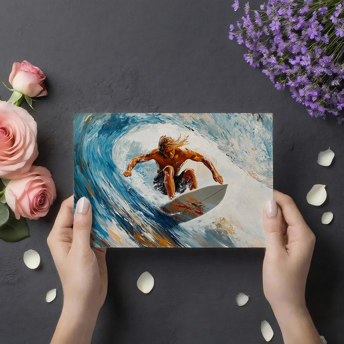 Person holding a postcard with a surfer design, surrounded by flowers and petals on a dark surface.