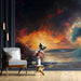 Living room with a large wall mural of a surfer on a surfboard against a vibrant sunset sky.