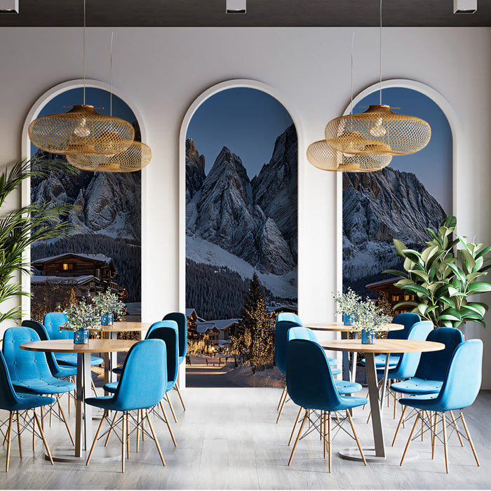 Modern dining area with blue chairs and wooden tables, featuring a mountain landscape in the background.