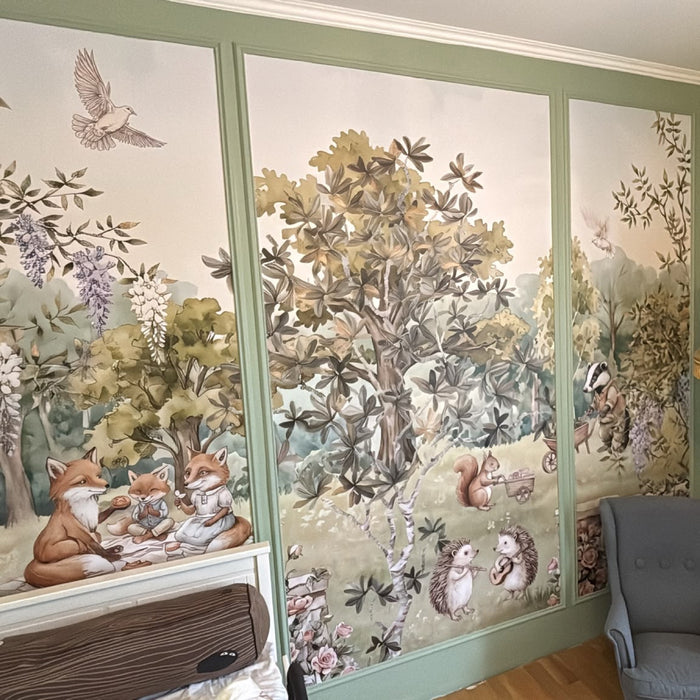 Customer photo: Enchanted Woodland Picnic mural installed in a nursery with green panelling